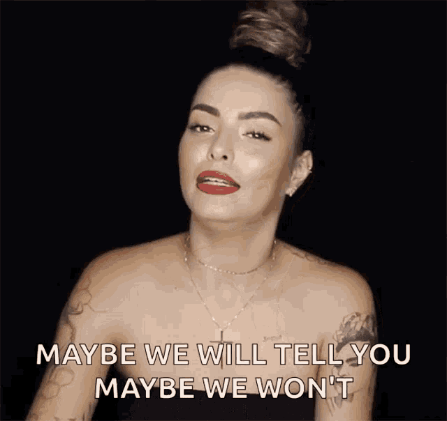 a woman is pointing at the camera and says maybe we will tell you maybe we won t