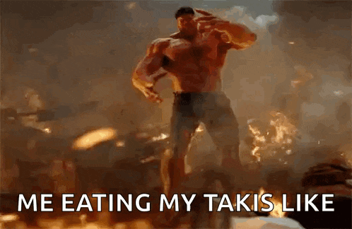 a shirtless man is standing in front of a fire with the words `` me eating my takis like '' written below him .