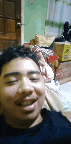 a man sitting in front of a door with a box that says coca cola on it