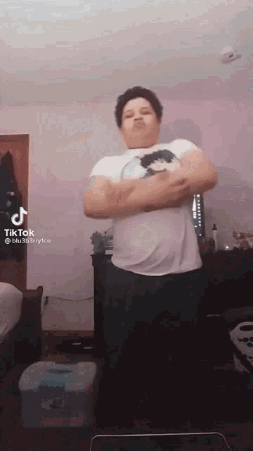 a tiktok video of a person dancing with a purple wall in the background