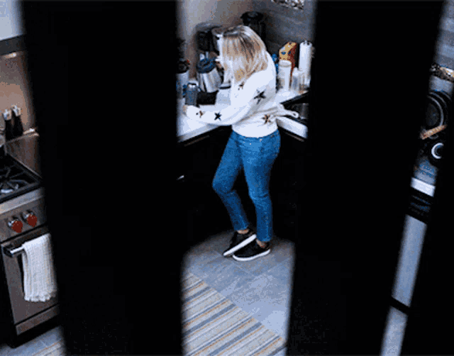 a woman in a white sweater with stars on it