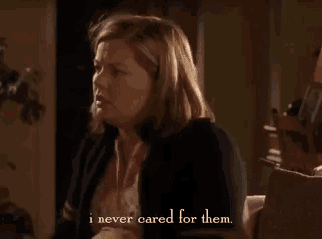 a woman is sitting on a couch talking to a man and says `` i never cared for them '' .