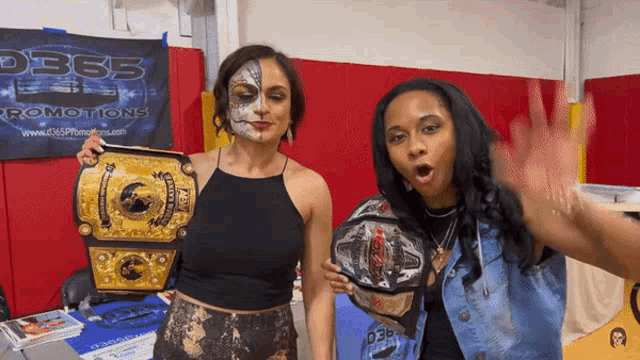 two women standing in front of a d365 promotions sign