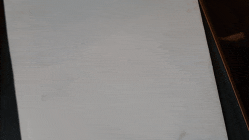 a close up of a white surface with a few spots