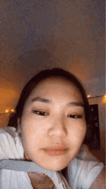 a close up of a woman 's face with a blurred background .