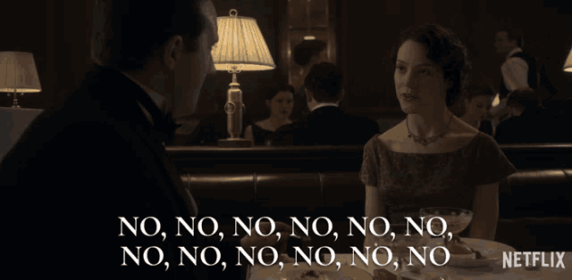 a man and a woman are sitting at a table with the words no no no no no no no on the bottom