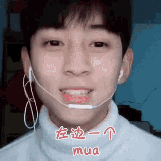 a young man wearing a headset and earphones is smiling and making a funny face .