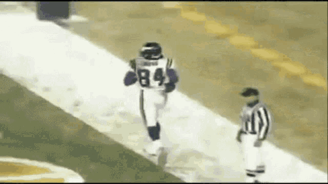 a football player with the number 84 on his jersey is running down the field