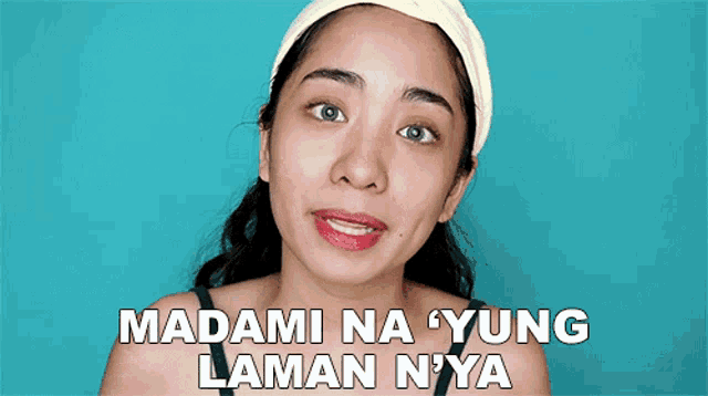 a woman wearing a headband with the words " madami na yung laman nya " above her