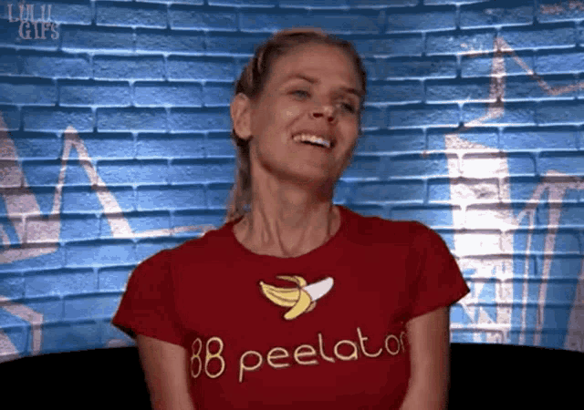 a woman wearing a red shirt that says " 88 peelator "