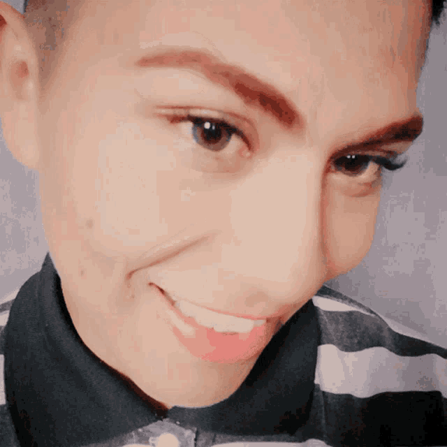 a close up of a person 's face with a smile on their face