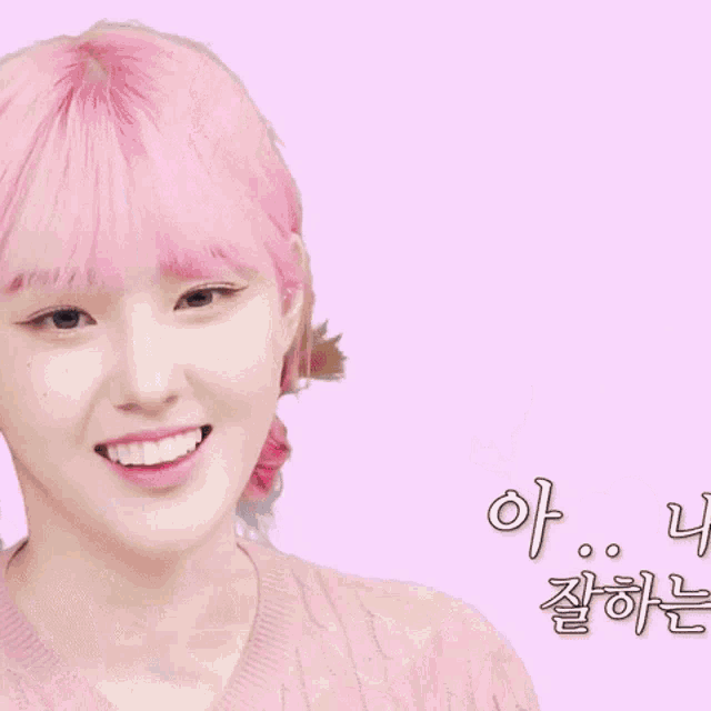 a girl with pink hair is giving a peace sign while sitting next to two other girls