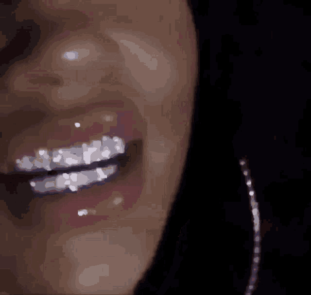 a close up of a woman 's mouth with braces .