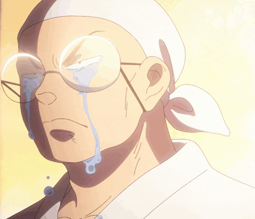 a man with glasses and a headband is crying