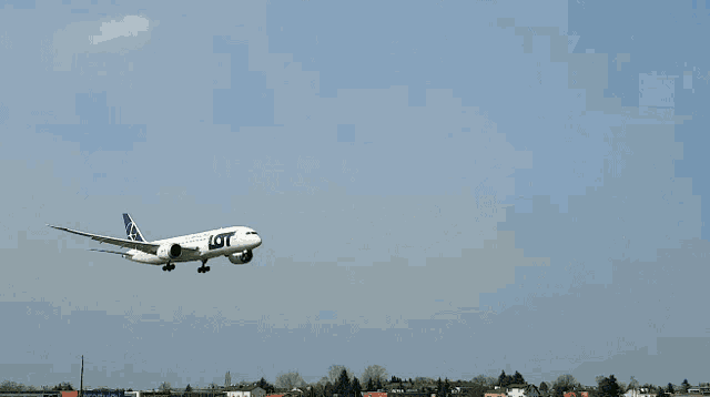 a polish airlines plane is flying in the sky