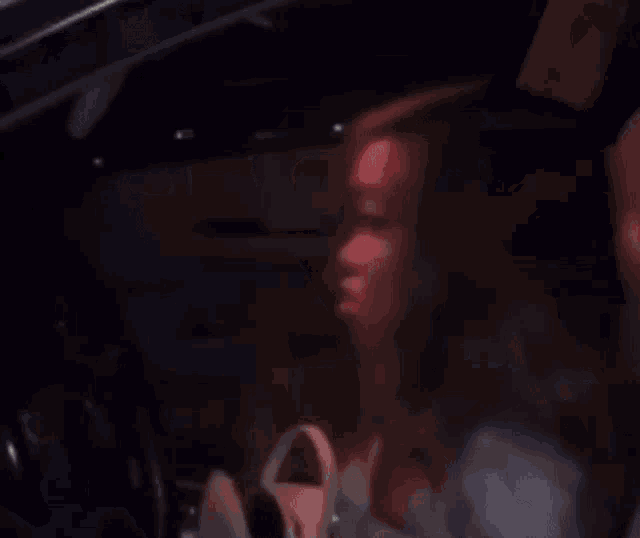 a dark room with a light coming out of the window