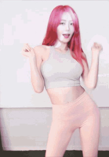 a woman with red hair is wearing pink leggings