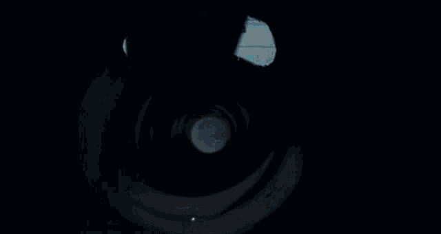 a person is holding a flashlight inside of a tunnel