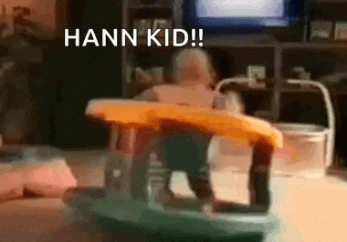 a baby is sitting in a walker with the words hann kid written in the background .