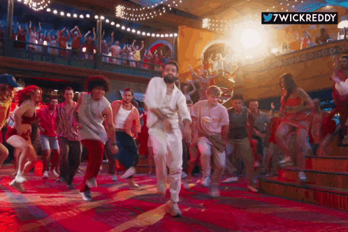 a group of people are dancing in a room with a 7wickreddy logo