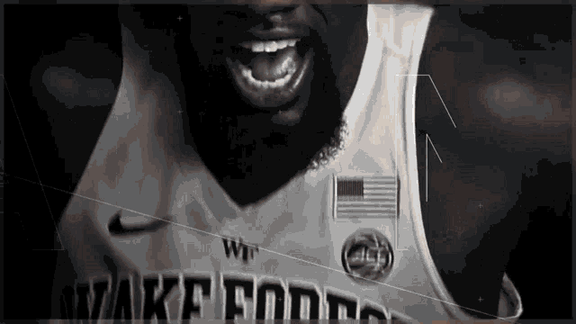 a black and white photo of a basketball player with his mouth open