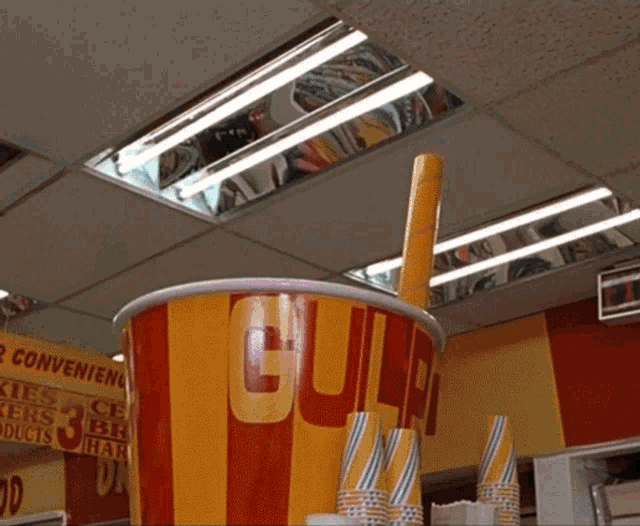 a large cup with a straw and a sign that says 3 for $ 3