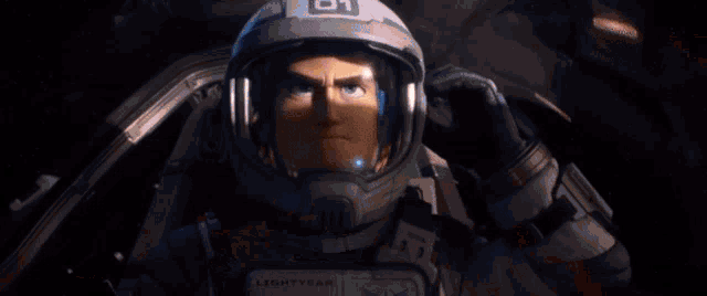 buzz lightyear is wearing a helmet and taking a selfie in a spaceship .