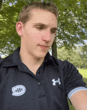 a young man wearing a black shirt with a white logo that says abd