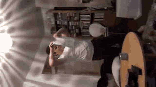 a man is laying on the floor taking a picture of himself in a living room .