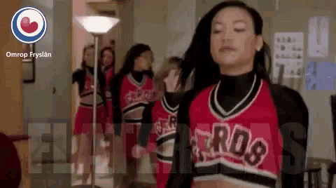 a group of cheerleaders are standing in a hallway with the word ros on their uniforms