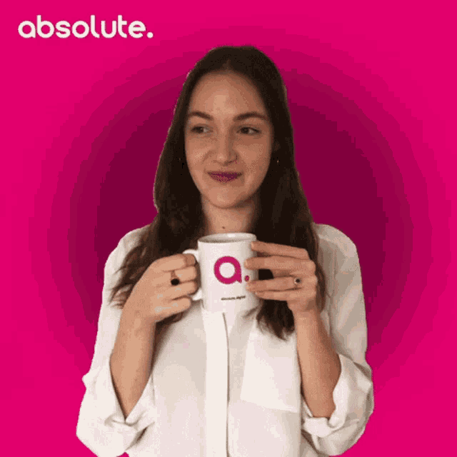 a woman in a white shirt is holding a mug that says absolute