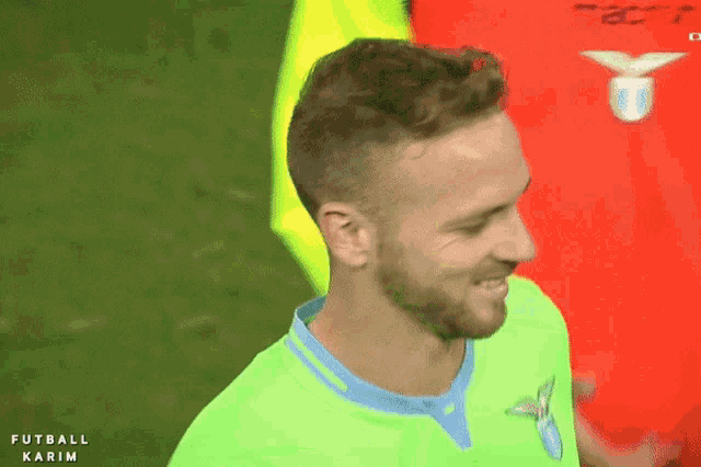 a soccer player wearing a green shirt with the word futbol karim on the bottom
