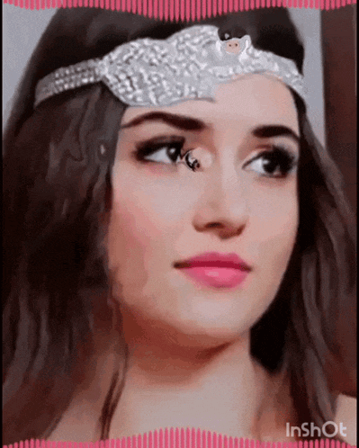a close up of a woman 's face wearing a tiara