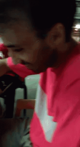 a man wearing a pink shirt with the word nike on the sleeve