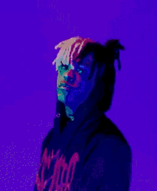 a man wearing a revenge hoodie is holding a purple object in his hand