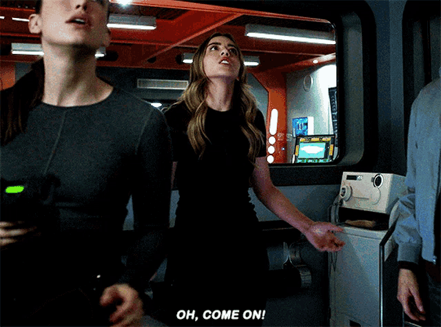 a woman says " oh come on " while standing in a room