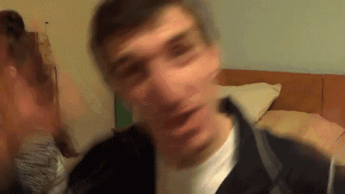 a blurry picture of a man 's face with a woman behind him