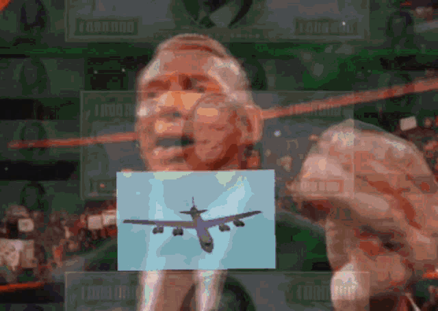 a man in a suit is holding a picture of an airplane in front of him