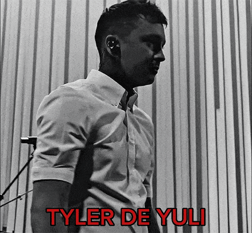a black and white photo of a man with the name tyler de yuli