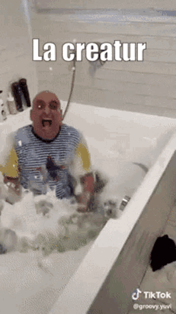 a man is sitting in a bathtub with the words la creatur on the bottom