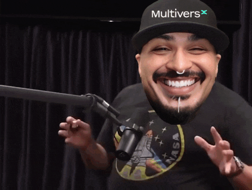 a man wearing headphones is laughing in front of a microphone while sitting in front of a brick wall .