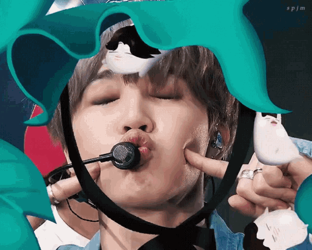 a close up of a person 's face with a microphone in his mouth