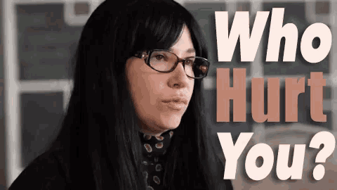 a woman wearing glasses and a wig is asking who hurt you .