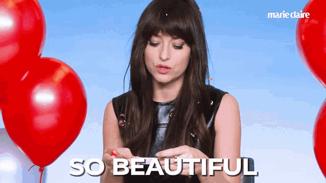 a woman with red balloons and the words so beautiful