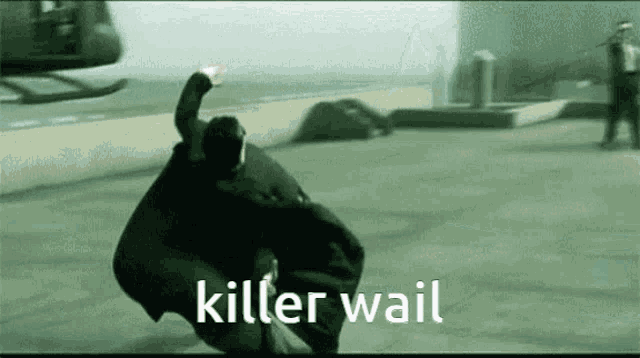a man in a black suit is being chased by a helicopter and the words killer wail are visible