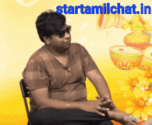 a man wearing sunglasses is sitting in front of a yellow background with the words starttamilchat.in on it