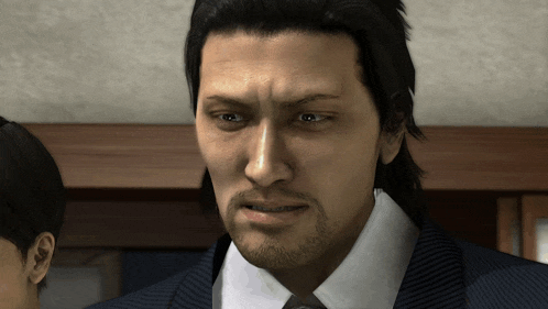 a man with a beard wearing a suit and tie looks at the camera