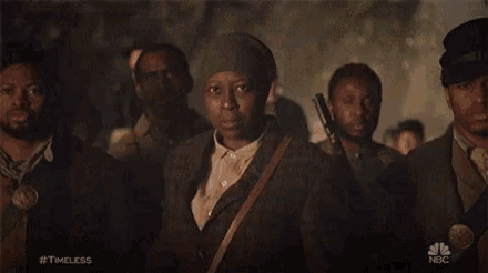 a group of men are standing in front of a sign that says #timeless