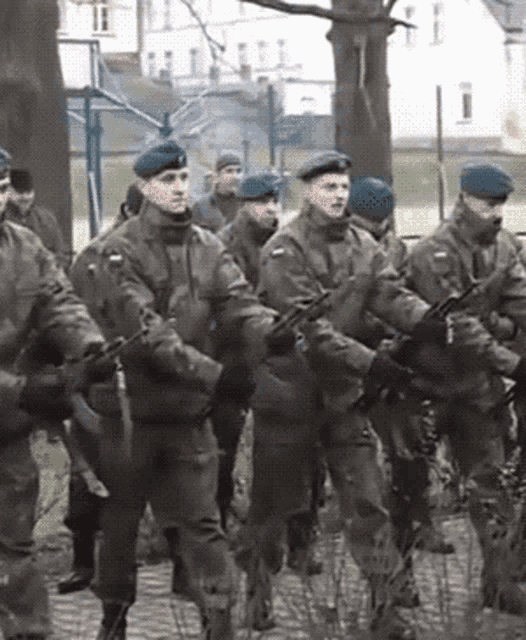 a group of soldiers marching in a line with their guns