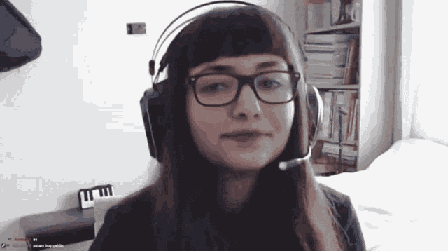 a woman wearing glasses and headphones with a microphone on her head